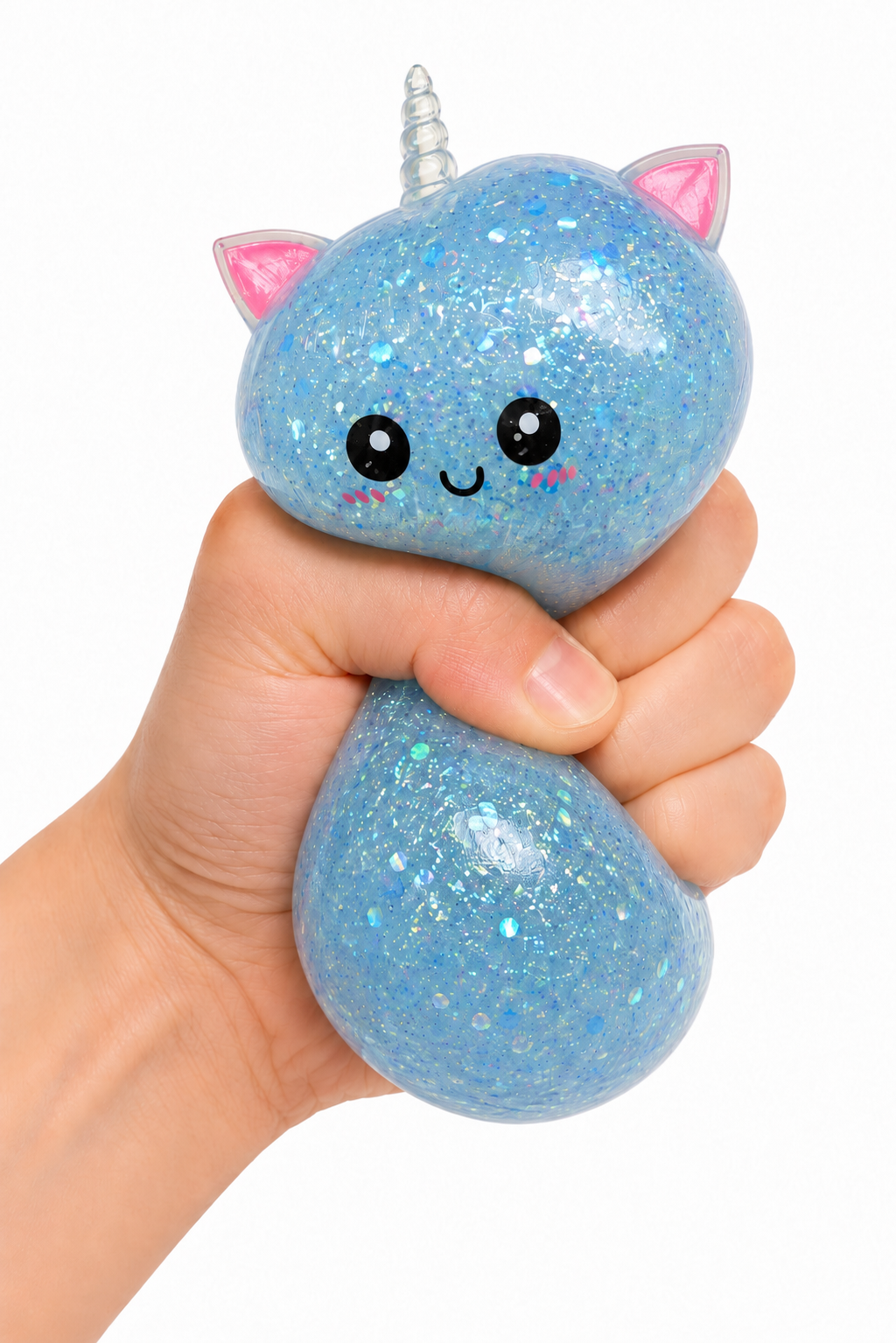 A hand holding a blue glittery cat-shaped squishy toy with pink ears, a silver horn, and a cute face against a white background.